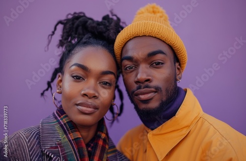 an africanamerican couple posing together on purple background