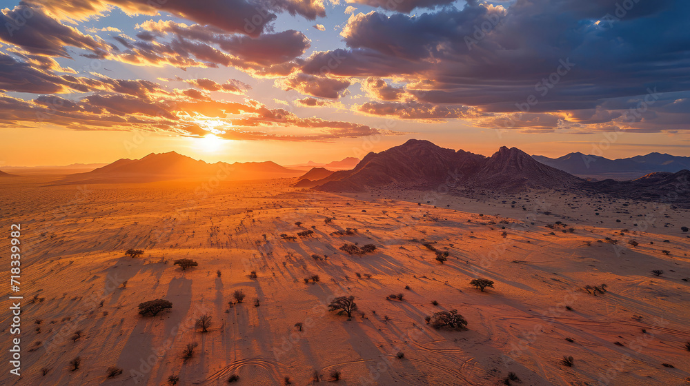 Fototapeta premium aerial sunrise with shadows over desert terrain.