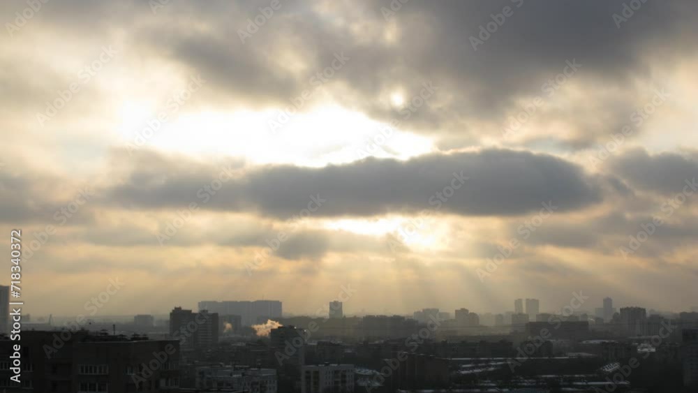 Winter town with chimneys, the suns rays make way through the clouds Winter town with chimneys, the suns rays make way through the clouds