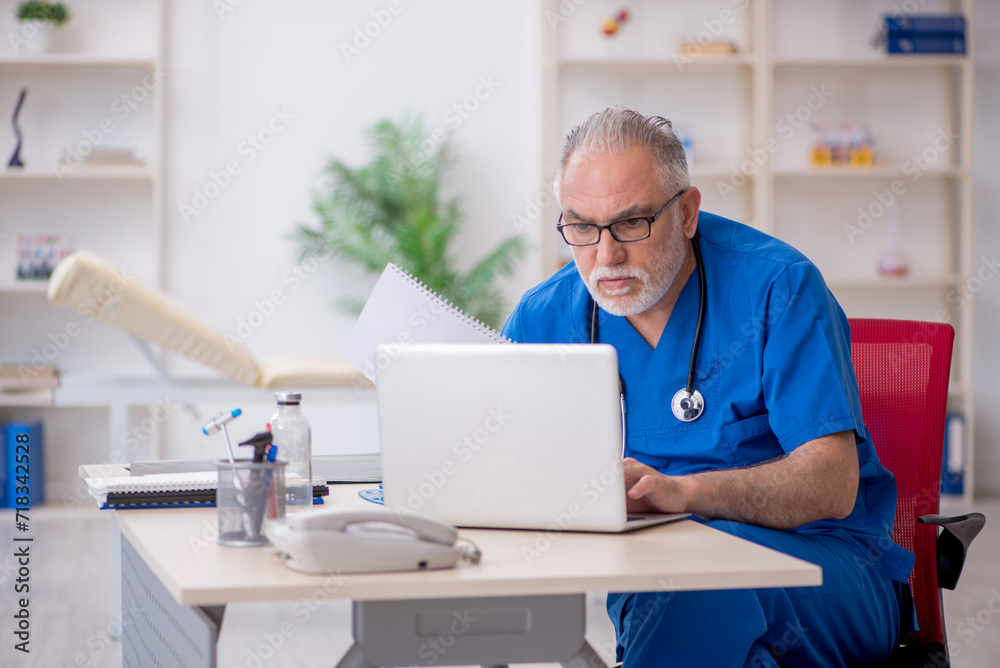 Old male doctor in telemedicine concept Old male doctor in telemedicine concept