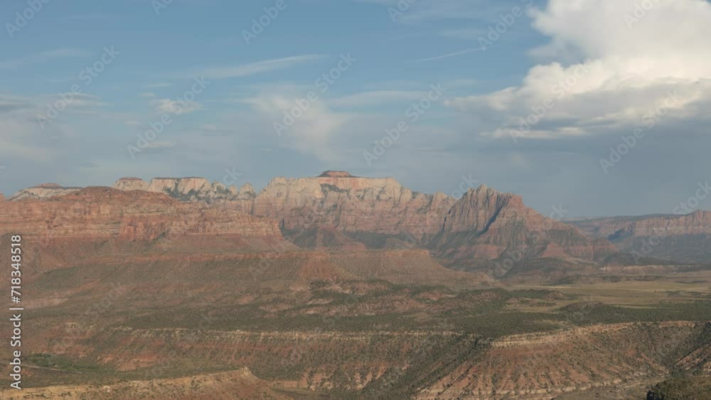 4k time lapse of West Temple Mountain on the western edge of Zion Nat. Park, Utah, USA in the warm light of the setting sun as clouds drift overhead and the shadow of evening slips over the landscape 4k time lapse of West Temple Mountain on the western edge of Zion Nat. Park, Utah, USA in the warm light of the setting sun as clouds drift overhead and the shadow of evening slips over the landscape