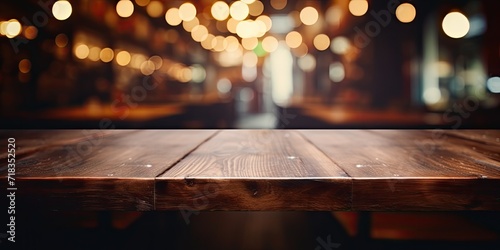 Empty table top on dark blurry cafe background for your display.