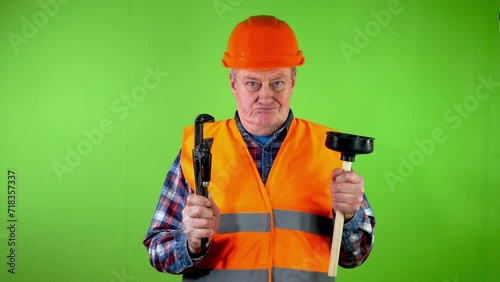 Old plumber with adjustable wrench and toilet plunger, boast his job.