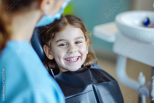 child sitting in a dental chair with a dentist examining their teeth