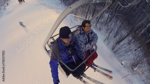 Man makes selfie with friend on cableway in ski resort, top view photo