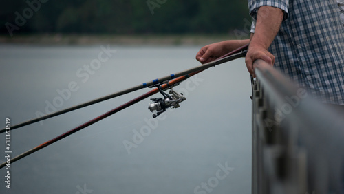 two fishermen catch fish in the lake with fishing rods