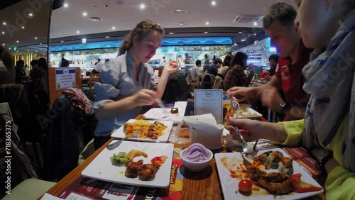 Family pairs eat in fast-food restaurant Todai. Timelapse