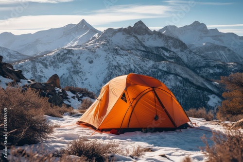an orange tent set up in the mountains
