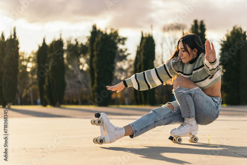 Young Woman Stretching One Leg Performing Artistic Stunt on Quad Roller Skates. Young brunette skating while doing a tough skill. photo