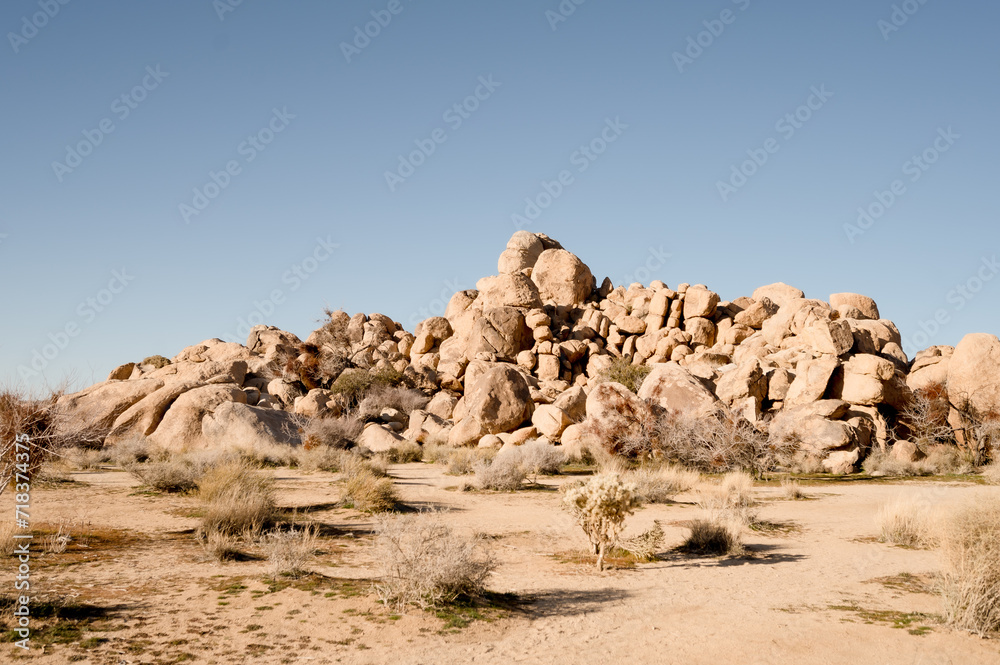 Color photo of desert boulders with on clear blue sky, american southwest