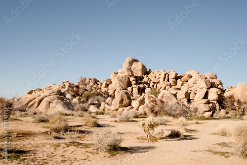 Color photo of desert boulders with on clear blue sky, american southwest