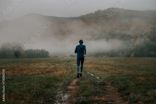 A Youthful Trail Runner Navigating the Mystical Fog of Autumn