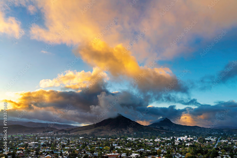 Dramatic light at sunrise, sunset with mountain peaks, city, town