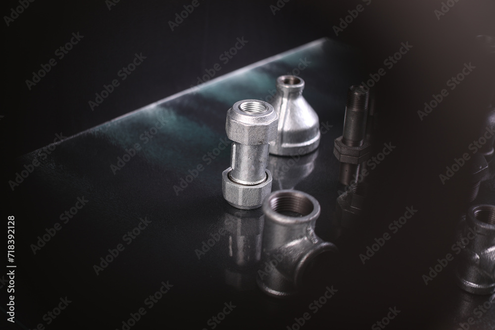 A set of metal and copper water pipe parts, a water wrench and pipe elbows, blue and red colors, black background, different shapes and different sizes A set of metal and copper water pipe parts, a water wrench and pipe elbows, blue and red colors, black background, different shapes and different sizes