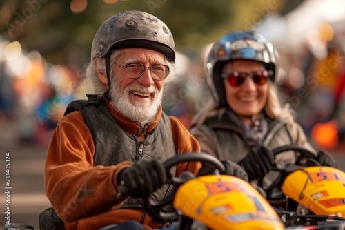 A couple of cheerful elderly people go karting © Александр Лобач