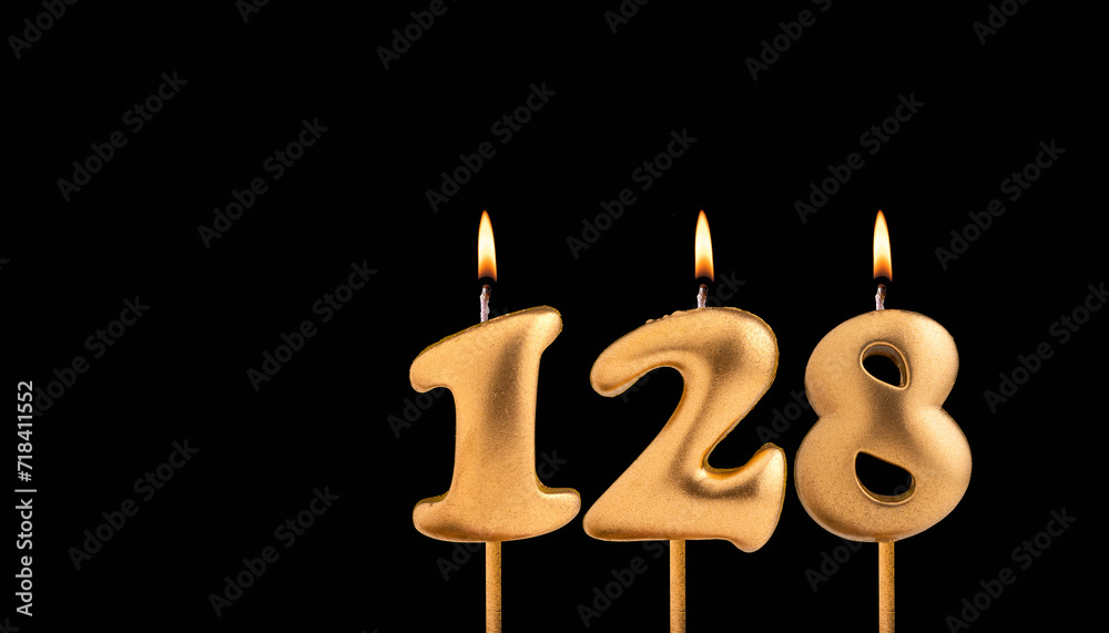 Golden candle 128 with flame - Birthday card on dark luxury background Golden candle 128 with flame - Birthday card on dark luxury background