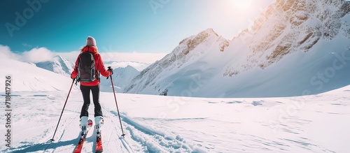 a woman snowshoeing in the mountains in winter
