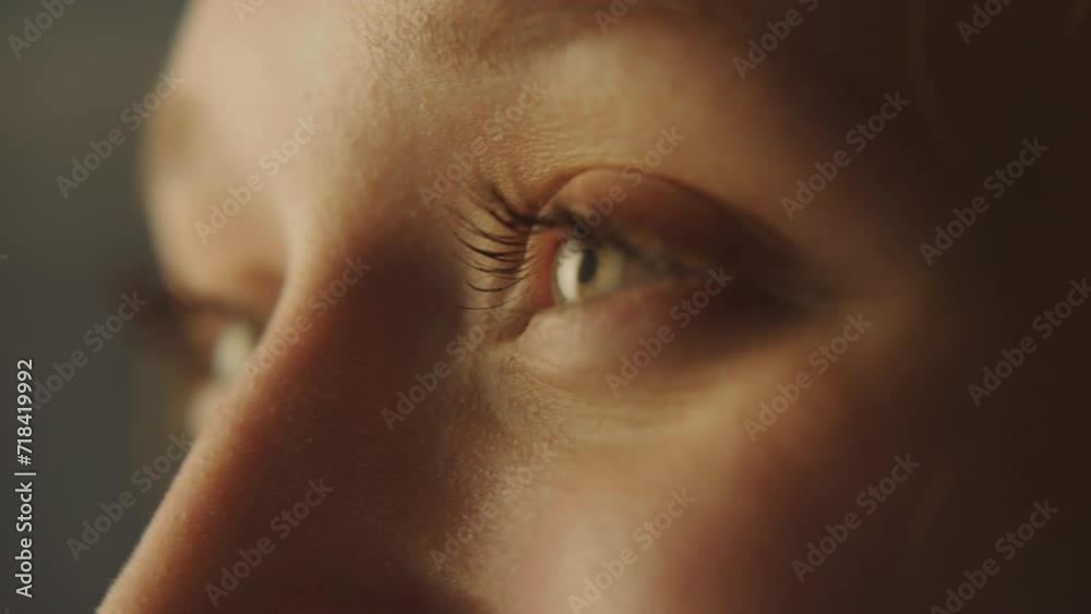 Close-up portrait of a young attractive woman opening her eyes and smiling