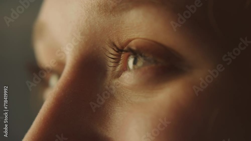 Close-up portrait of a young attractive woman opening her eyes and smiling