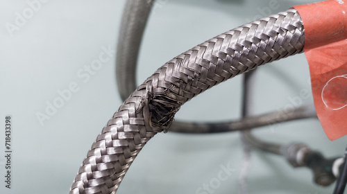 Example of flexible hose damage due to friction.