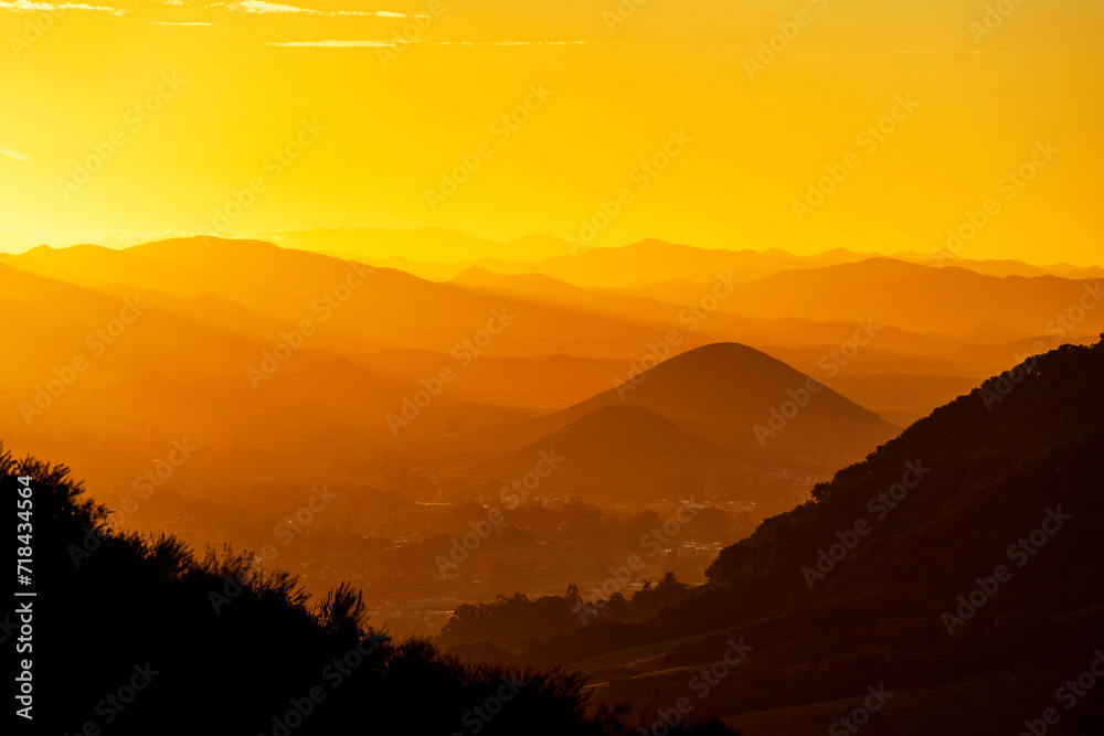 Sunrise, sunset with yellow light and mountains, hills