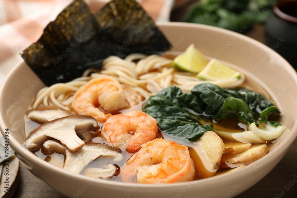 Delicious ramen with shrimps and mushrooms in bowl on table, closeup. Noodle soup Delicious ramen with shrimps and mushrooms in bowl on table, closeup. Noodle soup