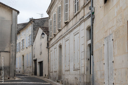 Fototapeta Naklejka Na Ścianę i Meble -  View on old streets and houses in Cognac white wine region, Charente, walking in town Cognac with strong spirits distillation industry, France