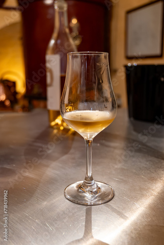 Tasting of cognac spirit aged in old French oak barrels in cellar in distillery in Cognac white wine region  Charente  Segonzac  Grand Champagne  France
