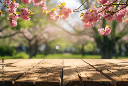 Empty wooden table in Sakura flower Park with garden bokeh background with a country outdoor theme Template mock up for display of product