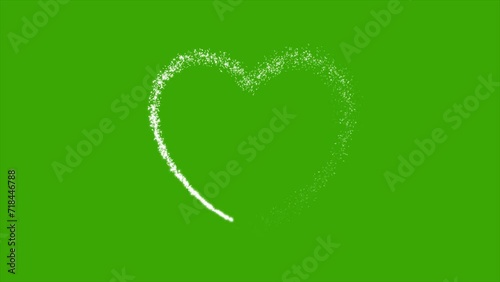 Heart shape formed by glitter particles on green screen background