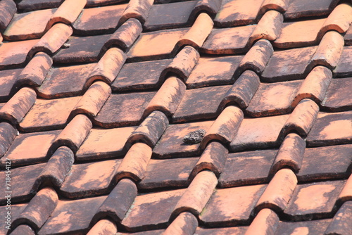 Red brick tile roof of house during the day