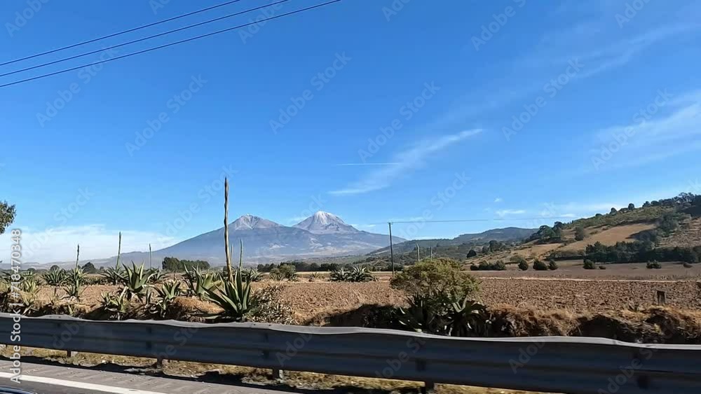 4k video of Sierra Negra volcano and Pico de Orizaba as seen from a moving car on the road. Mexico, landscape