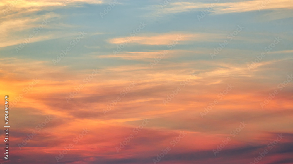 Sunset sky on twilight in the evening with orange gold sunset cloud nature sky backgrounds. Romantic summer sky at sunset.
