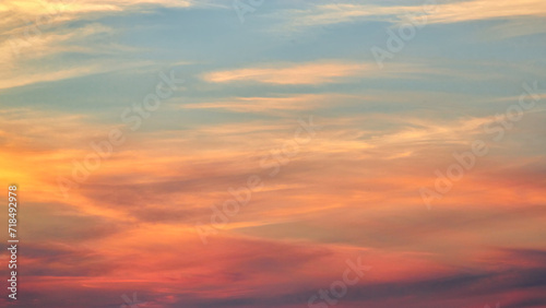 Sunset sky on twilight in the evening with orange gold sunset cloud nature sky backgrounds. Romantic summer sky at sunset.