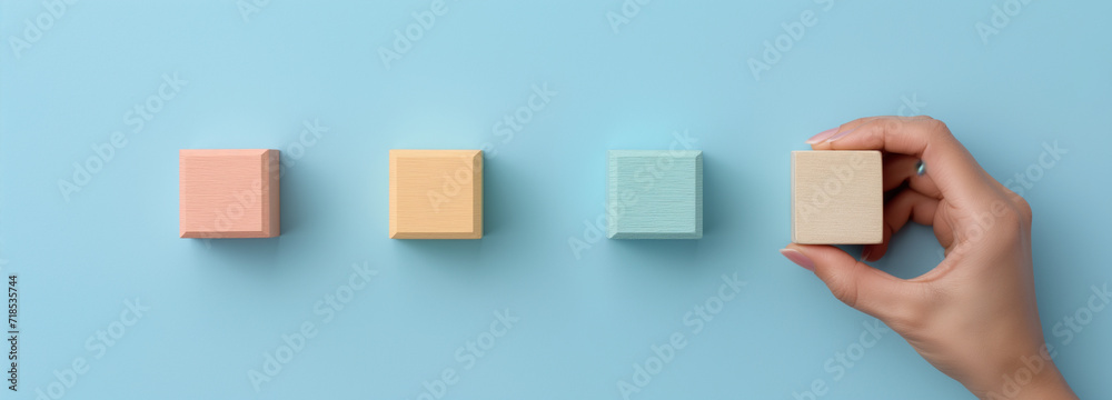 hand hold on wooden cubes hand hold on wooden cubes