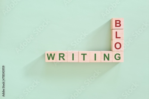 Blog writing concept. Crossword puzzle flat lay typography in green background.	 photo