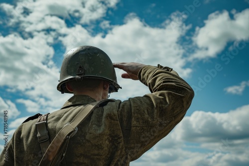 individual is wearing a greenish-brown uniform and a metal helmet