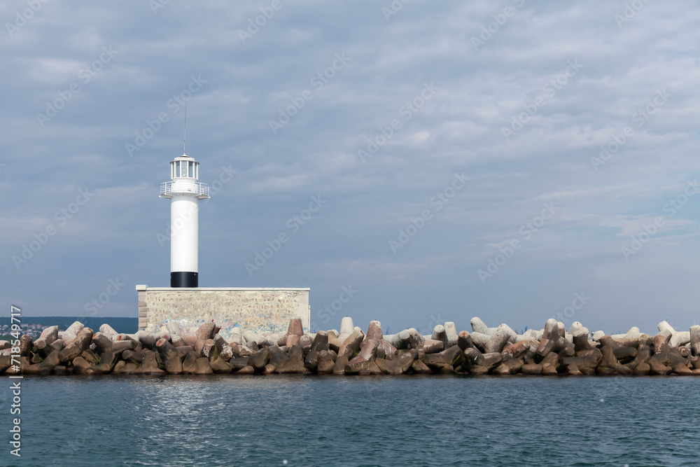 Breakwater with white lighthouse tower