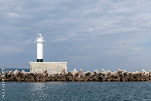 Breakwater with white lighthouse tower