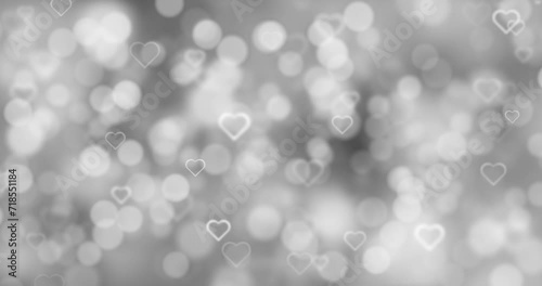Blurred silver white bokeh with glowing heart symbols loop motion background.