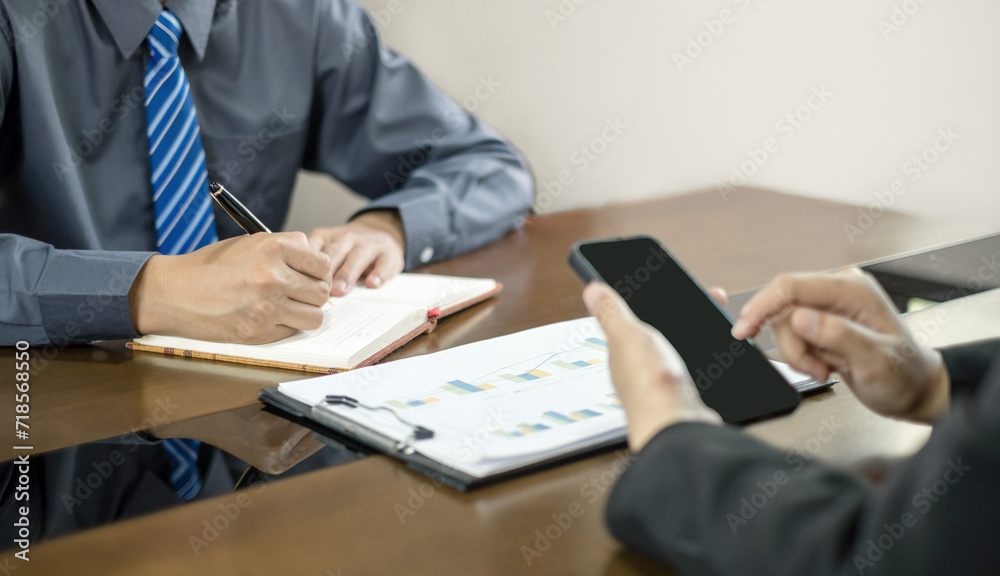 Two business leaders talk about charts, financial graphs showing results are analyzing and calculating planning strategies, business success building processes