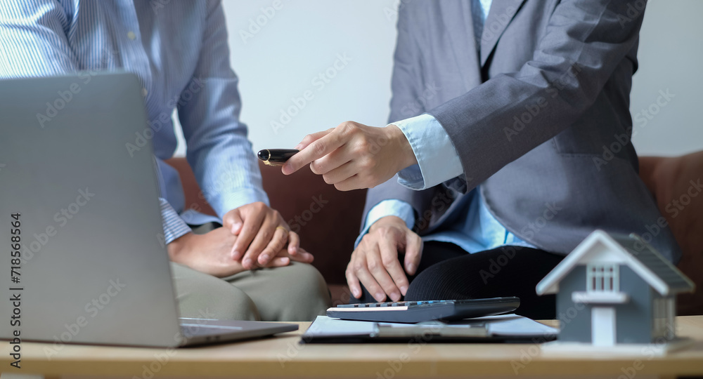 Real estate agents offer sale home insurance is talking to clients about buying home insurance. Home insurance concept Real estate agents offer sale home insurance is talking to clients about buying home insurance. Home insurance concept