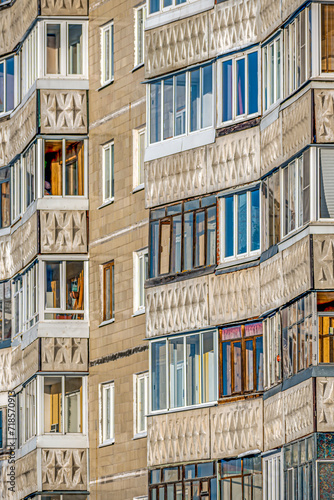 A fragment of the facade of a multi-storey residential building on a winter day