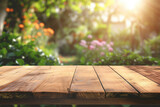 
A wooden table with no objects on it and a blurred outdoor garden background. The wooden table provides space for text and can be used for marketing promotions