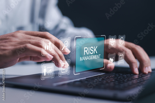 Businessman use laptop with virtual icon of Risk analysis in business decisions. Risk control and management strategies for risky businesses, Risk management concept. photo
