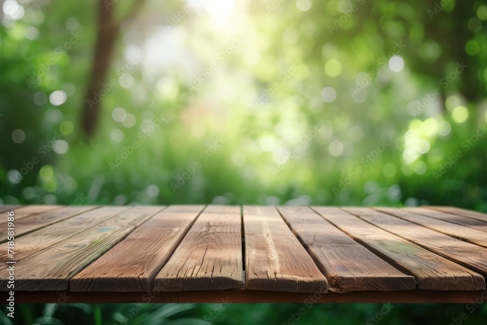 Empty wooden table top in a blurred green garden background Empty wooden table top in a blurred green garden background