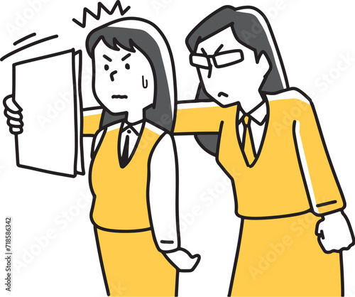 書類の間違いを指摘する女性社員