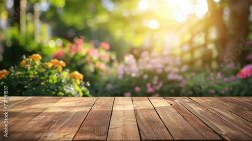 Wooden table with blurred garden background decorated for a party © Cheetose