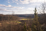 looking through the treetops to the river valley and the fields in autumn colors 