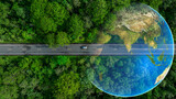 Aerial top view of green electric vehicle car driving over straight forest road, EV car electric vihicle car on forest road with globe green energy and eco power produced from sustainable.